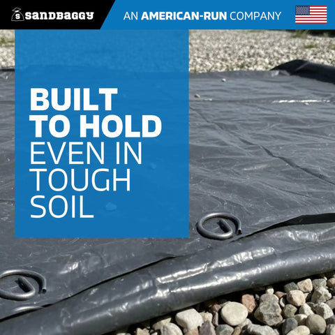 Image of landscape staples securing fabric in soil, showing Beefed Up Heavy Duty 6 Inch Landscape Staples With 8 Gauge Galvanized Circle Top Ground Pins For Weed Barrier Fabric Sod Turf Netting Erosion Control And Drip Irrigation Lines, Pack Of 100.