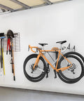 Wall Mounted Double Bike Rack Foldable For Two Bikes Space Saving Indoor Garage Storage Solution With Low Lift Access And Easy Cleaning For Home Garage Use Easy Install Holds Two Bikes Securely Horizontal Mount installed on wall with two bikes hanging.