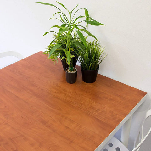 Calvados Wood Self Adhesive Film Roll 17 By 78 Inches 4 Pack With Applicator applied on a table surface with plants