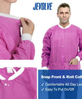 Man wearing pink 50 pack disposable lab coats for adults hip length with pockets and knit cuffs 45gsm SMS multi layer fabric