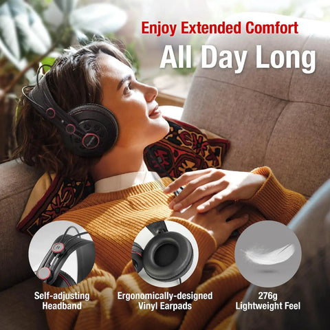 Woman relaxing on couch wearing semi open over ear studio headphones with 50mm neodymium drivers. Lightweight and comfortable.