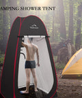 Instant Pop Up Privacy Tent 3.9x3.9x6.9 Ft large portable changing room with a person inside, set up in a forest