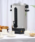 100 Cup Coffee Urn And Hot Beverage Dispenser With Dripless Faucet, stainless steel on a table with pastries and cups, side view