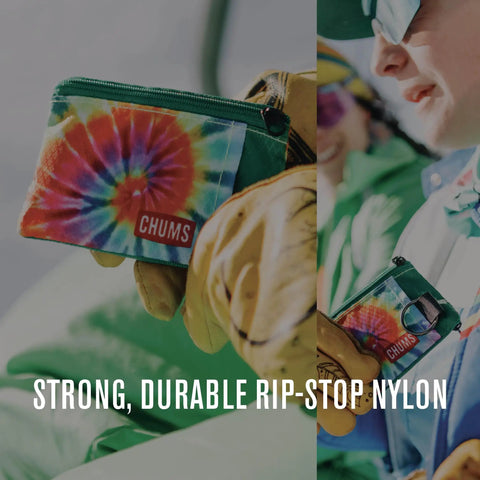 Person holding Surfshorts Wallet Slim Card Holder With RFID Blocking Clear ID Window Zippered Water Resistant Key Ring Ultra Compact Pocket Wallet For Front Pocket And Everyday Carry, bright tie-dye pattern, durable rip-stop nylon.