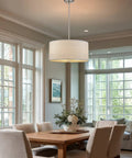Pearl 18 Inch Modern 3 Light Drum Pendant Chandelier hanging over wooden dining table in bright living room