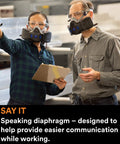 Two people wearing Half Face Respirator With Secure Click Fit Speaking Diaphragm And Push Button Seal Check Quad Flow Cartridges For Killer Breathability Pro Grade Comfort For Dust Sanding Grinding And Sawing HF802SD Medium, discussing in a workshop.