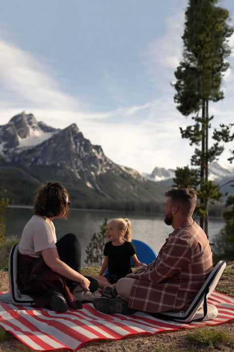 Family enjoying Go Anywhere Camping Chair With Padded Seat And Backrest Adjustable And Ultra Portable Lightweight Blue Alloy Steel Frame