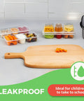 8 Oz Reusable Snack Containers With Lids Three Compartment Snack Pack Set BPA Free on kitchen counter with cutting board
