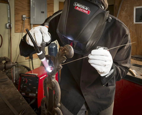 Welder using torch with Viking Industrial Passive Black Welding Helmet for MIG TIG and Stick Welding, heavy duty safety gear.