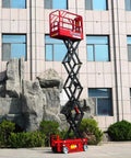 Industrial Scissor Lift Platform For Smooth Cargo Transfer And Equipment Maintenance Hydraulic Lifter raised against a building.