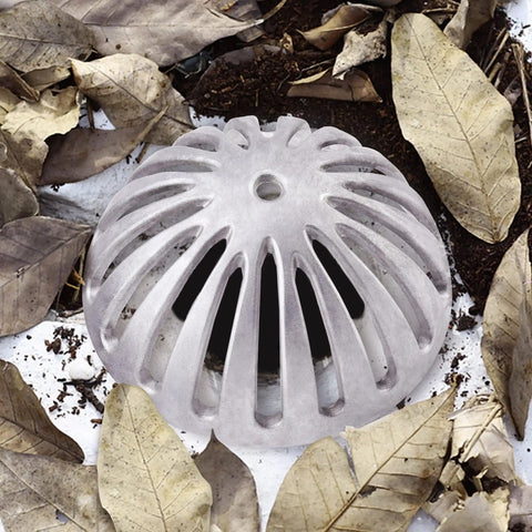 Heavy Duty Aluminum Floor Drain Dome Cover 5-1/2 Inch Width By 2-1/4 Inch Height surrounded by leaves and soil