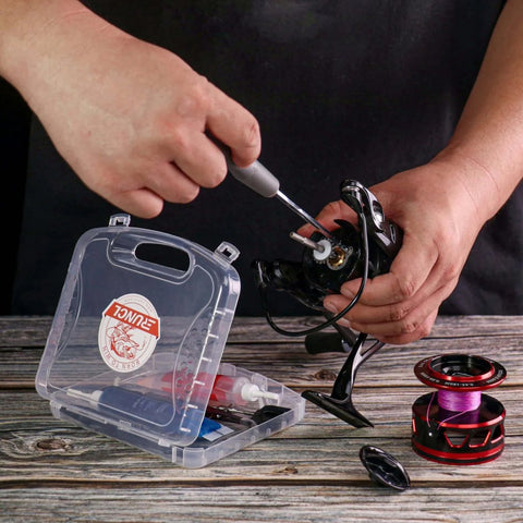 Person using 8 In 1 Fishing Reel Repair Kit With Bearing Puller Magnetic Screwdriver Wrench Tweezers Cleaning Brush