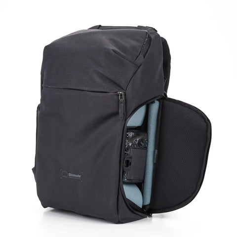 Urban Explore 30L Camera Backpack with open side pocket revealing interior gear storage, durable anthracite shell, carry on friendly.