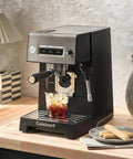 Professional Grade Home Espresso Maker Featuring Solid Twenty Bar Pressure And A Stainless Steel Bottomless Portafilter brewing iced coffee.