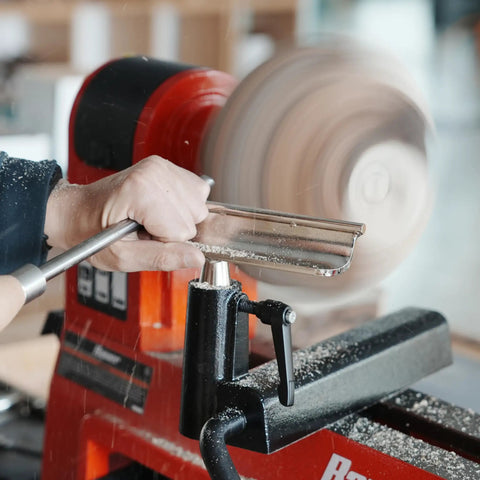 Heavy Duty 1 Inch Diameter Woodturning Lathe Tool Rest Set with hardened steel bars in use, shaping a wooden piece while cutting.