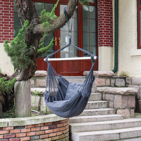 Gray hammock chair hanging rope swing with steel spreader bar and cushions, outdoor setup on porch, supports up to 500 lbs
