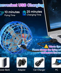 Hand Controlled Flying Orb Ball Toy With RGB Lights charging via USB plugged into a laptop, with power accessories shown.