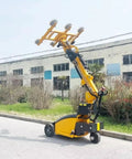 Heavy duty electric vacuum lifter for large glass panels outdoors, featuring adjustable suction cups for easy handling.