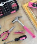 39 Piece General Household Tool Set In Toolbox Storage Case With Essential Hand Tools For Everyday Home Repairs DIY And Crafts Pink Ribbon Edition Includes Hammer Pliers Wrench Tape Measure Utility Knife Magnetic Level And More displayed on wood surface with pink and black accents.