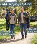 Two people carrying Big And Tall Rocking Camping Chair With 400 Lb Capacity in carry bags, walking on a trail