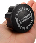 Upgrade Your Ride With These Killer Pull Pin Spring Knobs For Exercise Bikes And Cycling Machines Featuring A Solid 18mm Thread Design Made From Durable Abs Plastic And Iron To Keep Your Indoor Fitness Gear Locked In Tight And Ready For Intense Workouts. Black adjustable pull knob held in a hand for exercise bike adjustment.
