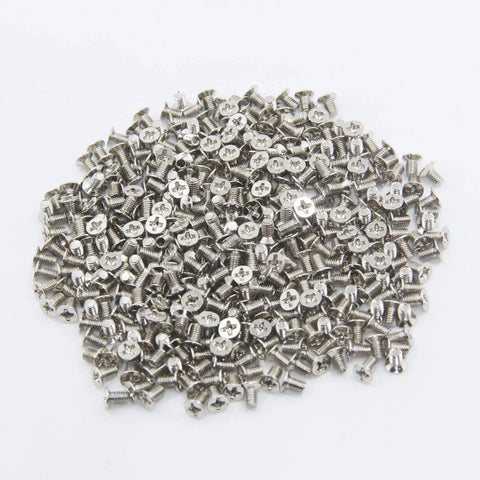 Rock Solid M3x5mm Flat Head Phillips Screws 100 Pack For 2.5 Inch SSD And Hard Drives, nickel plated alloy steel screws in a pile.