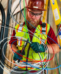 Electrician working with multiple colored wires, including THHN 10 AWG Copper Wire Red 100 Ft Roll Indoor Outdoor 600V Rated For Branch Feeder.