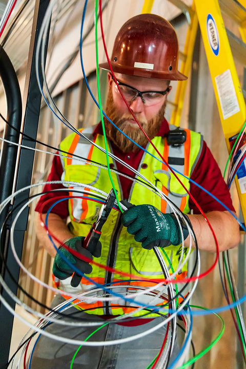 Electrician working with multiple colored wires, including THHN 10 AWG Copper Wire Red 100 Ft Roll Indoor Outdoor 600V Rated For Branch Feeder.