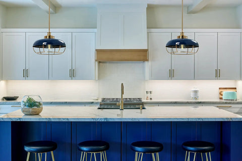 Industrial Caged Dome Metal Ceiling Light in Brushed Brass and Navy Blue Two Tone Finish hangs over a modern kitchen island