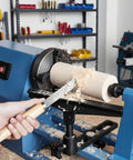 Kickstart Your Woodworking Game With This Smooth Mini Lathe Machine! Featuring 380W Power, 4-Speed Adjustments From 750 To 2150 RPM, And A Split-Type Tool Rest For Precise Turning And Sanding Projects. A close-up of a wood lathe in use, shaping a wooden cylinder.
