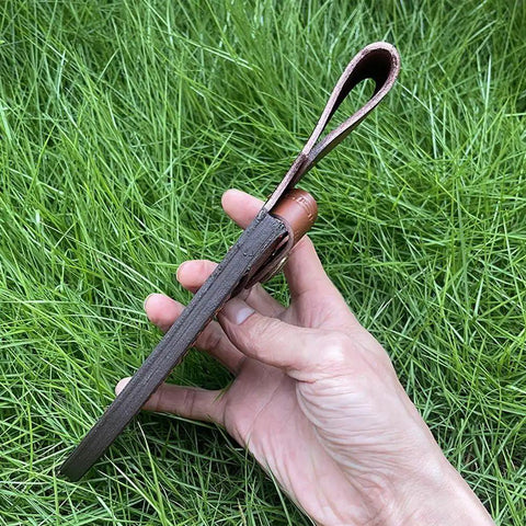 Rugged Leather Knife Sheath For Fixed Blade Knives With Secure Buckle Scabbard Pouch shown held in hand with grass background