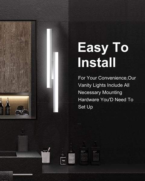 Modern bathroom with two 24-inch brushed nickel LED vanity lights mounted vertically on dark wall.