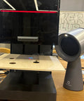 Heavy Duty Solder Fume Extractor Fan With Badass Suction And Slick Design For Desktop DIY Stations next to a laser cutter.