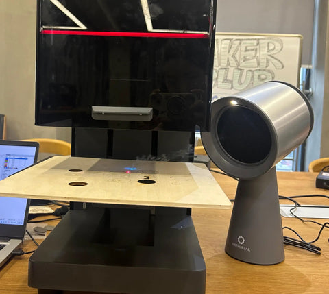 Heavy Duty Solder Fume Extractor Fan With Badass Suction And Slick Design For Desktop DIY Stations next to a laser cutter.