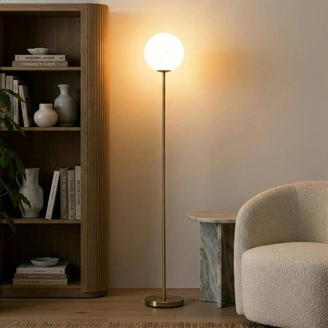 Luna LED Floor Lamp Dope Modern Tall Light For Living Rooms And Home Offices With Frosted Glass Globe Mid Century Style Standing Lamp In Brass Gold Finish Perfect For Reading In The Bedroom And Cozy Vibes next to bookshelf