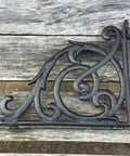 Rock Solid Cast Iron Shelf Brackets Heavy Duty Wall Mount Braces Vintage Metal Corbels Powder Coated Black Finish on wood.