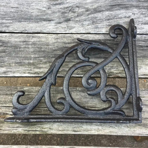 Rock Solid Cast Iron Shelf Brackets Heavy Duty Wall Mount Braces Vintage Metal Corbels Powder Coated Black Finish on wood.