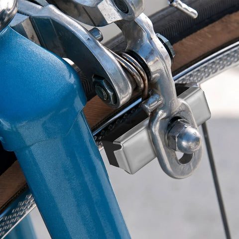 Close-up of 8 Pack Bike Brake Pads 40mm Universal Caliper Replacement Set on blue bike, showing metal bolt and installation.