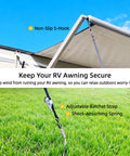 RV Awning Tie Down Kit With Shock Absorbing Springs And 13ft Ratchet Straps securing an awning on grass with blue sky background
