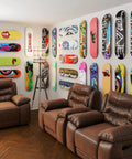 Room with multiple skateboards mounted using Skateboard Deck Display Wall Mount For Hanging And Showing Off Your Board Fits Most Decks With 1.625 Inch Truck Holes Easy Install Wall Art And Decor For Skaters 1 Pack.