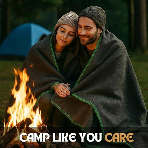 Couple wrapped in Go-To Rugged Wool Camping Blanket 70 Percent Wool, Fire Retardant, by campfire in forest