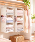 Beige Snap Together Six Tier Hanging Closet Organizer, Collapsible Wardrobe Rack For Dorms with folded clothes.
