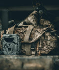 GoLive 4G LTE Trail Camera With Instant Live Streaming And Anti Theft GPS Tracking For Hunting And Wildlife Monitoring on a rugged bag.