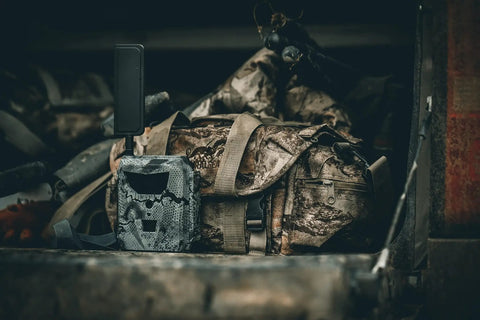 GoLive 4G LTE Trail Camera With Instant Live Streaming And Anti Theft GPS Tracking For Hunting And Wildlife Monitoring on a rugged bag.