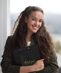 Smiling woman holding Black 4x8 Inch Bubble Mailers 50 Pack Padded Envelopes With Strong Adhesion And Cushioned Protection