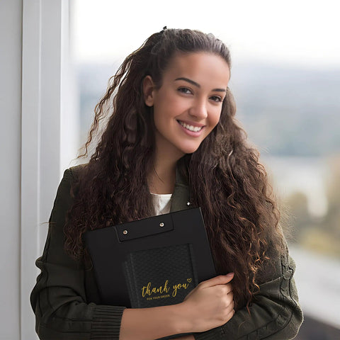 Smiling woman holding Black 4x8 Inch Bubble Mailers 50 Pack Padded Envelopes With Strong Adhesion And Cushioned Protection