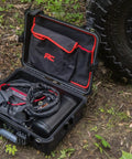 Tough As Nails Portable 12V Dual Cylinder Air Compressor Pump 150 Psi And 6 16 Cfm Fast Tire Inflator inside a sturdy case on dirt.
