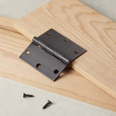 Heavy Duty 3x2 Inch Butt Hinges Black Finish 24 Pack with Plain Bearing on wooden surface