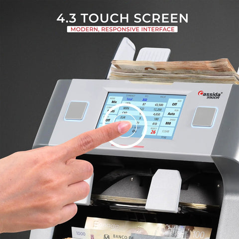 Cassida 9900R V2 Bill Counter Machine With Printer showing a hand using the 4.3 inch touch screen for settings.