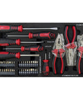 Assorted screwdrivers, pliers, and bit set organized in a black tray, part of a garage workshop tool box setup.